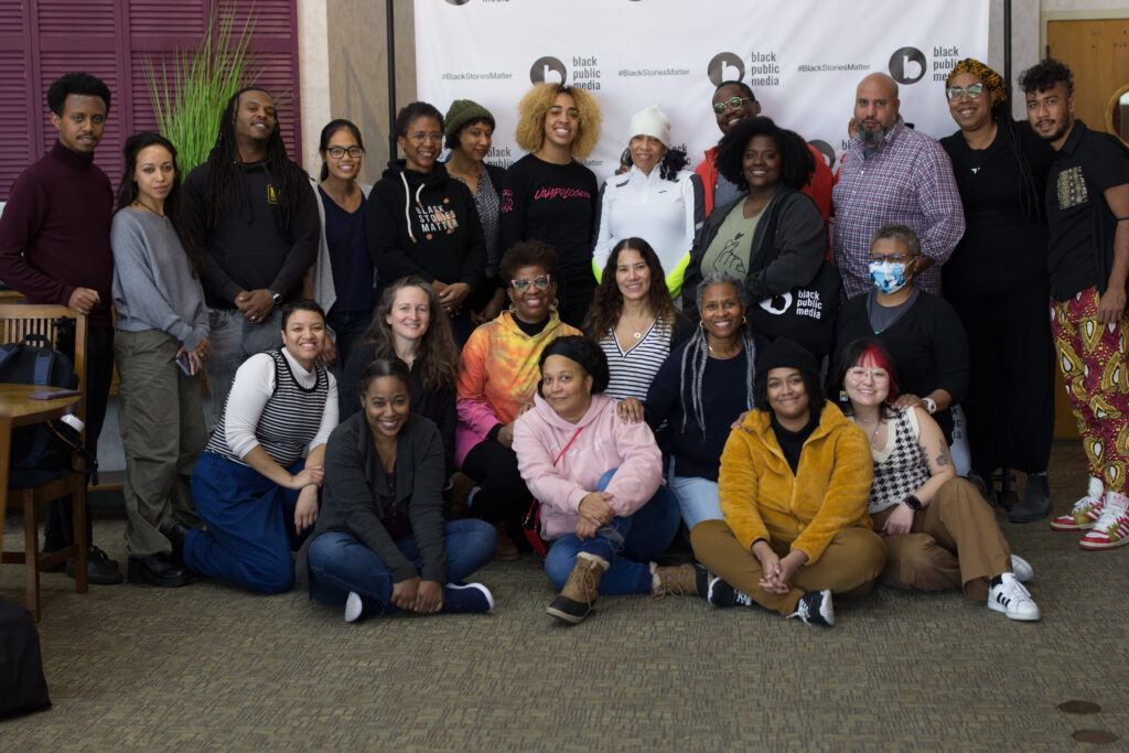 Standing behind the Black Public Media step-and-repeat at the Edith Macy Center from top to bottom: Kidus Hailesilasse, Ainslee Alem Robson, Damien McDuffie, Shan Shan Tam, Leslie Fields Cruz, Dawne Langford, Ashley O'Shay, Sandy Rattley, Dominick Rabrun, Eboni Zamani, Michael Premo, Angela Tucker, Leonardo Souza, Aja Evans, Cat Deakins, Marta Effinger-Crichlow, Soraya Selene, Luchina Fisher, Lisa Osborne, Sabrina Schmidt Gordon, Qiona Woffard, Chloe Cuffe, and Kat Walsh.