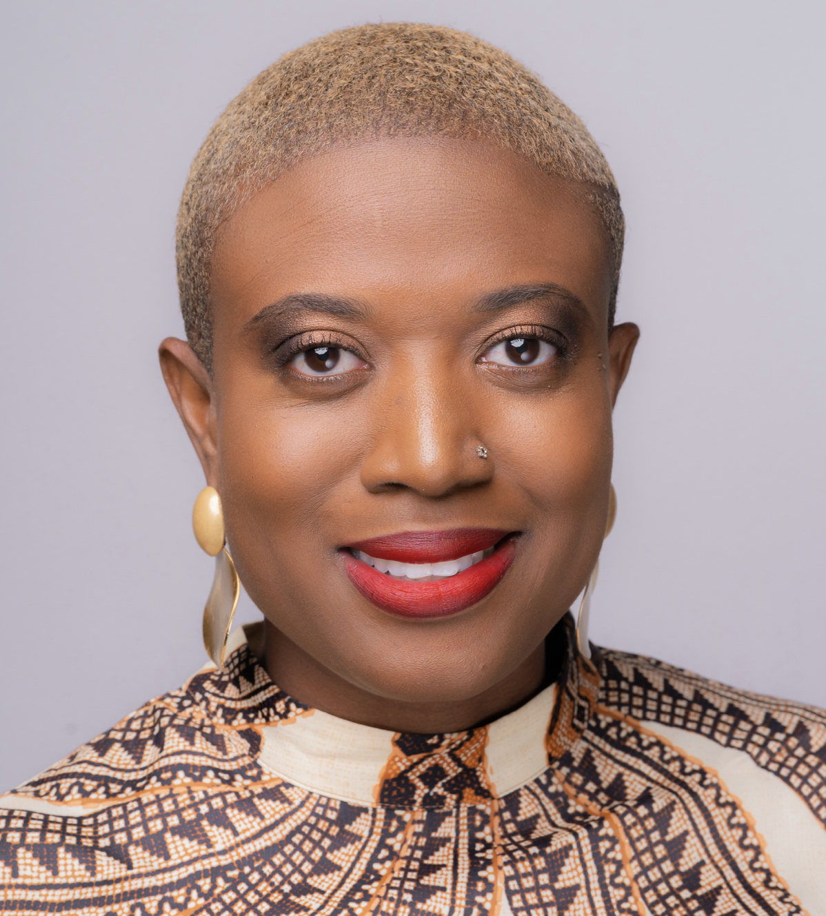 A headshot of Samantha Abrams against a neutral grey background.