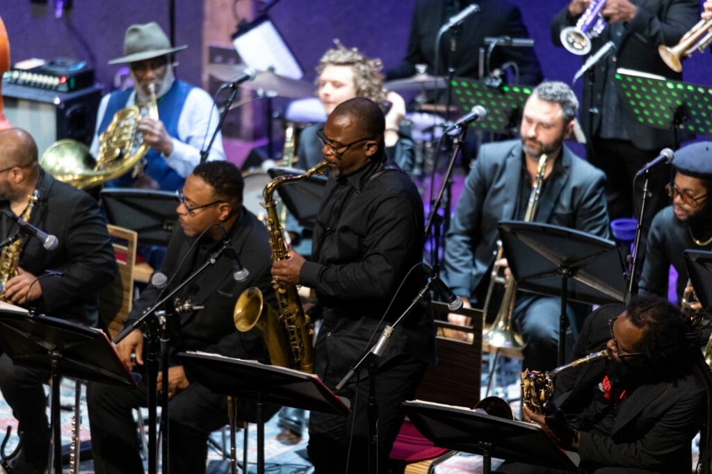 action shot of roy hargrove big band sax section playing a concert