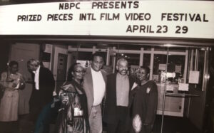 bpm founding members standing before a fim marquee