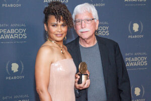 two filmmakers, woman on left, man to her right, holding their peabody award