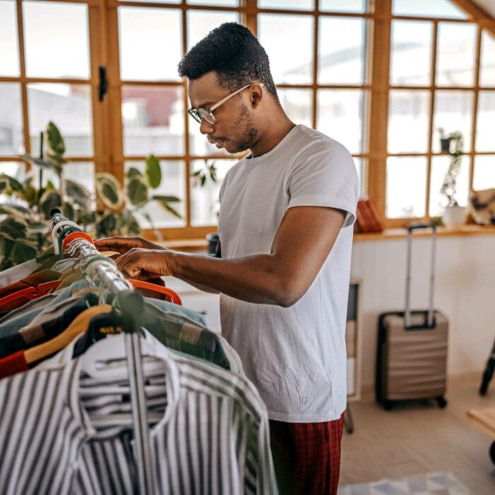 black man looking in closet