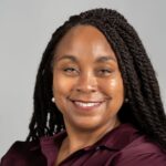 headshot of smiling woman in burgandy blouse