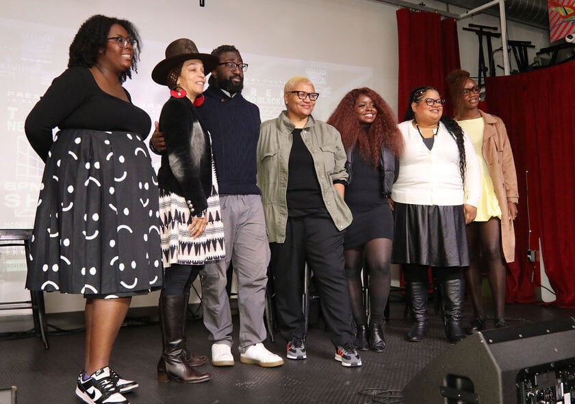 six bpmplus fellows stand on stage with Lisa Osborne