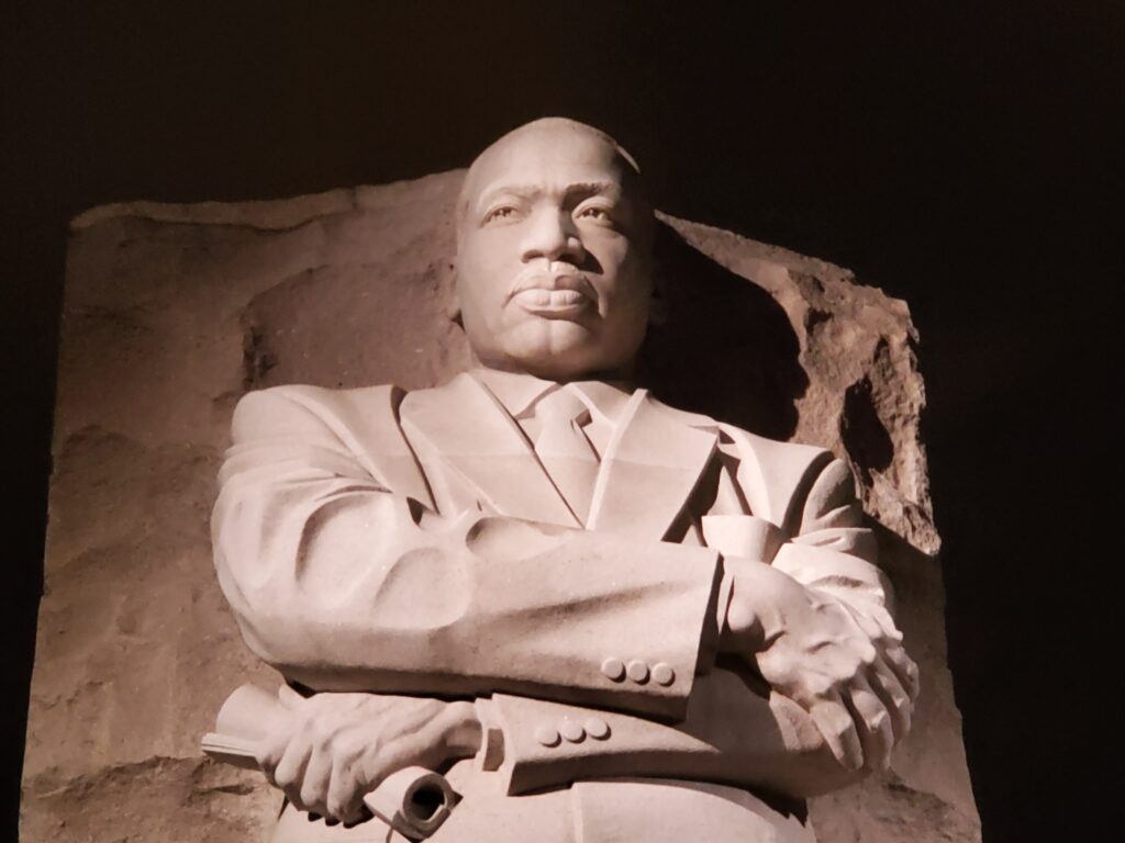 white stone monument of martin luther king jr against a dark sky