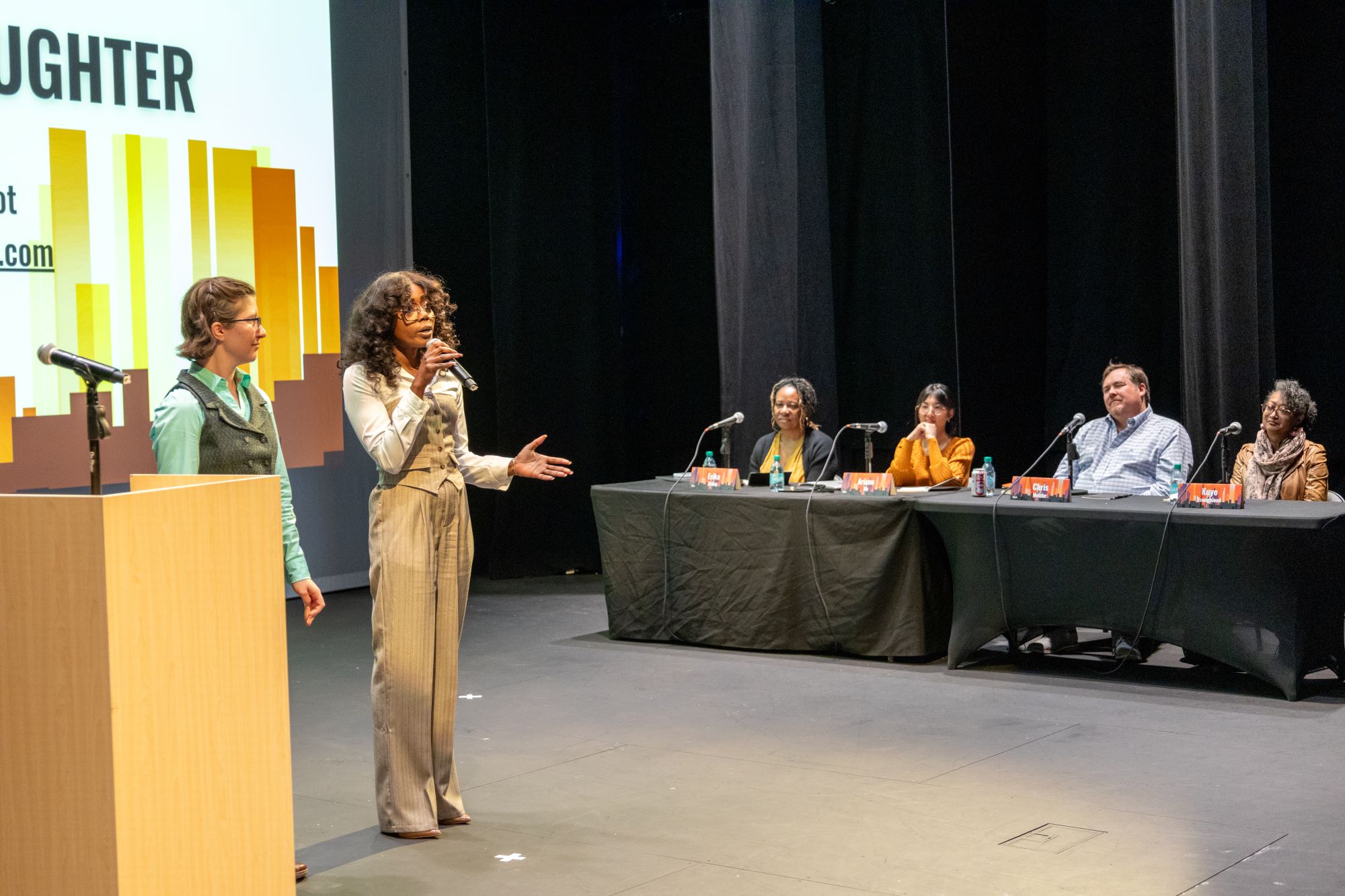 two women pitch project as panel of four looks on