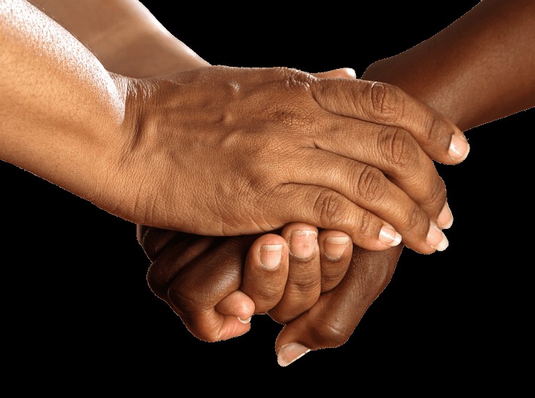 two sets of hands compassionally holding each other