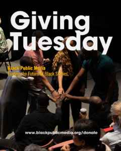 a circle of media makers pile their hands atop one another in solidarity.